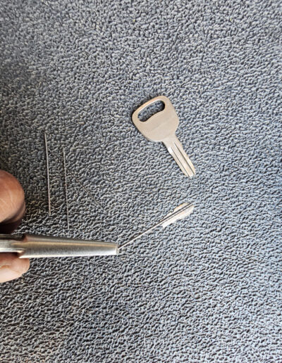 Broken piece of key extracted from car lock.