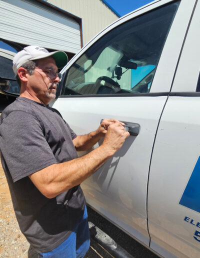 Man extracting key piece stuck in car lock.